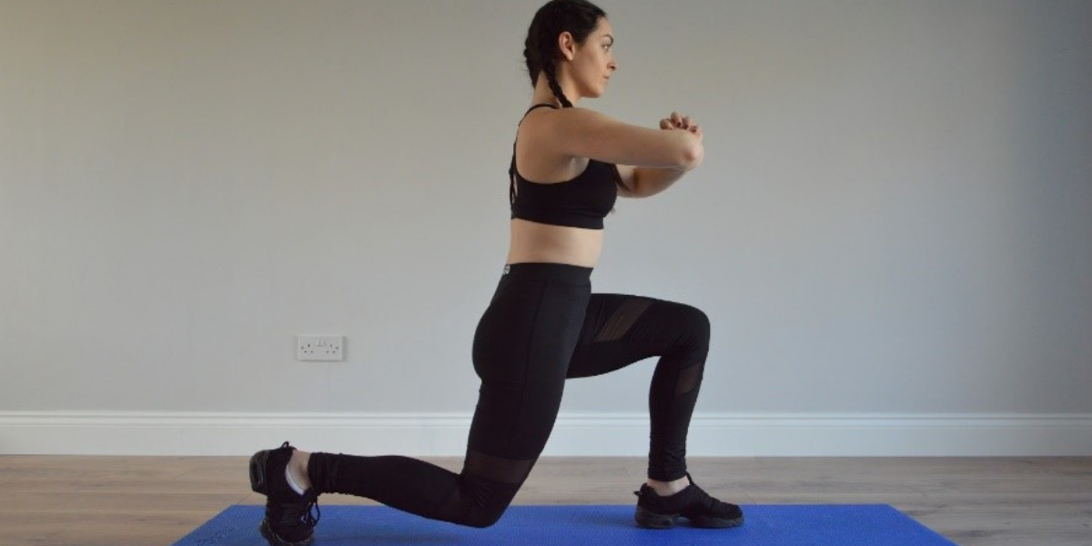 Girl on yoga mat performing lunge exercise